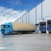 Unloading cargo truck at warehouse building