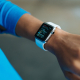Person wearing white silicone strap black smart watch