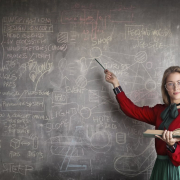 strict-female-teacher-with-book-pointing-at-scribbled-blackboard-stockpack-pexels.jpg Strict female teacher with book pointing at scribbled blackboard