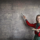 strict-female-teacher-with-book-pointing-at-scribbled-blackboard-stockpack-pexels.jpg Strict female teacher with book pointing at scribbled blackboard