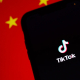 tiktok-running-on-an-iphone-chinas-flag-is-displayed-behind-it-stockpack-unsplash.jpg TikTok running on an iPhone. China's flag is displayed behind it.