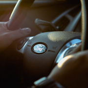 person-holding-ford-steering-wheel-stockpack-unsplash.jpg person holding Ford steering wheel