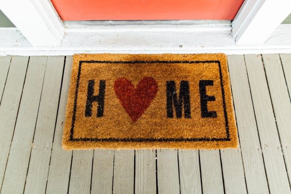 Brown home printed rug beside door