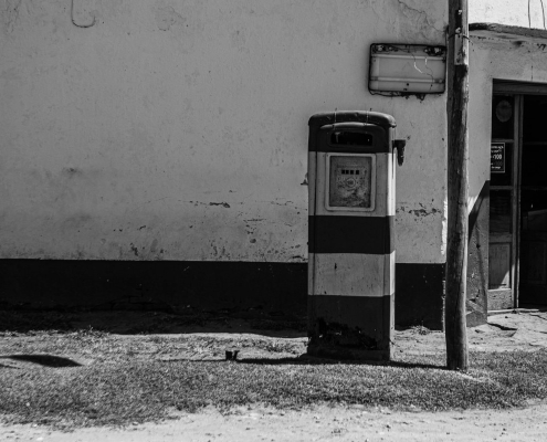 Old gas station on rough walkway on street