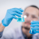 person-holding-glass-flasks-stockpack-pexels.jpg Person holding glass flasks