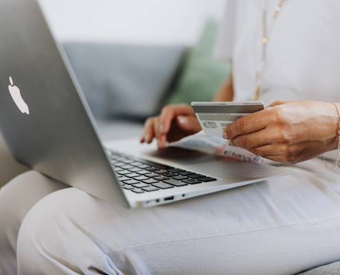 person-using-a-macbook-and-holding-a-credit-card-stockpack-pexels.jpg Person using a macbook and holding a credit card