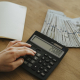 person-holding-black-desk-calculator-stockpack-pexels.jpg Person holding black desk calculator