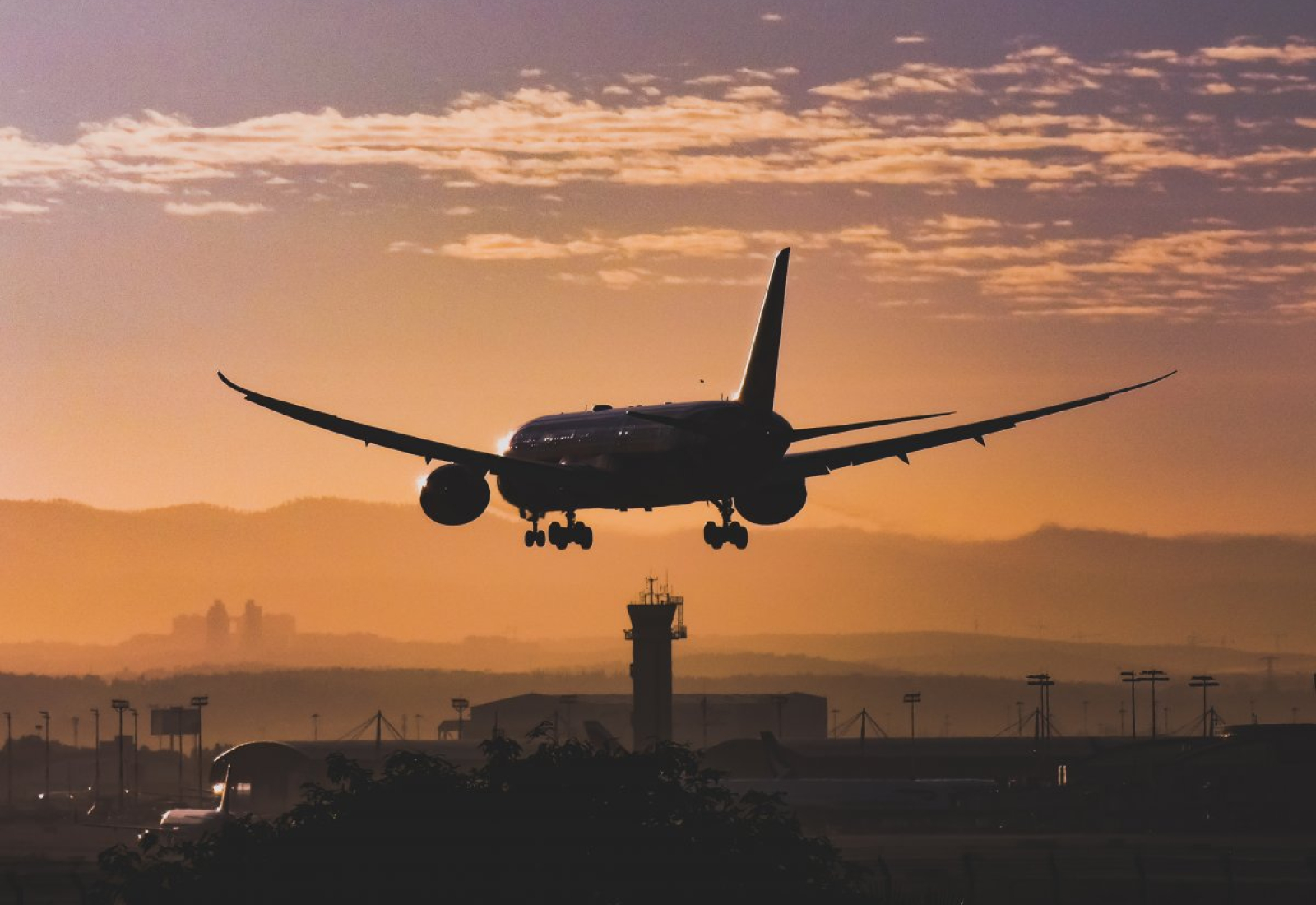 white-passenger-plane-flying-over-the-city-during-sunset-stockpack-pexels.jpg White passenger plane flying over the city during sunset