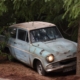 Old car parked near tree