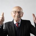 Positive senior man in eyeglasses showing thumbs up and looking at camera