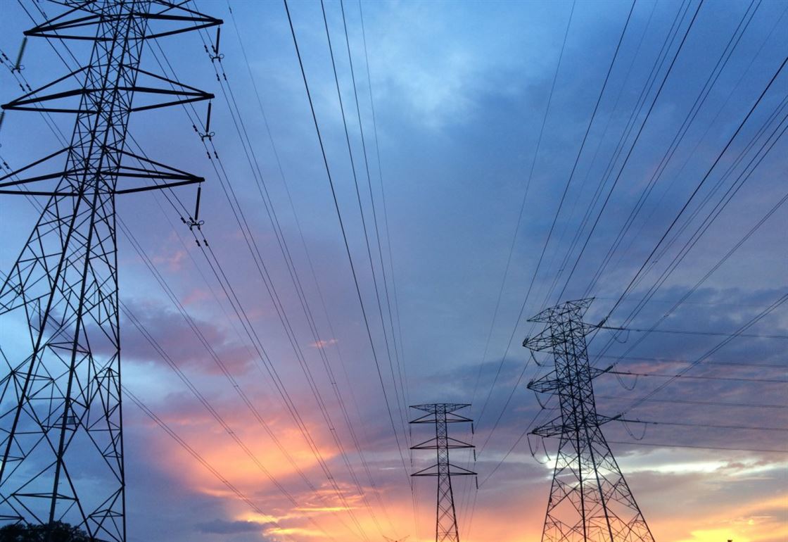 Transmission tower under gray sky