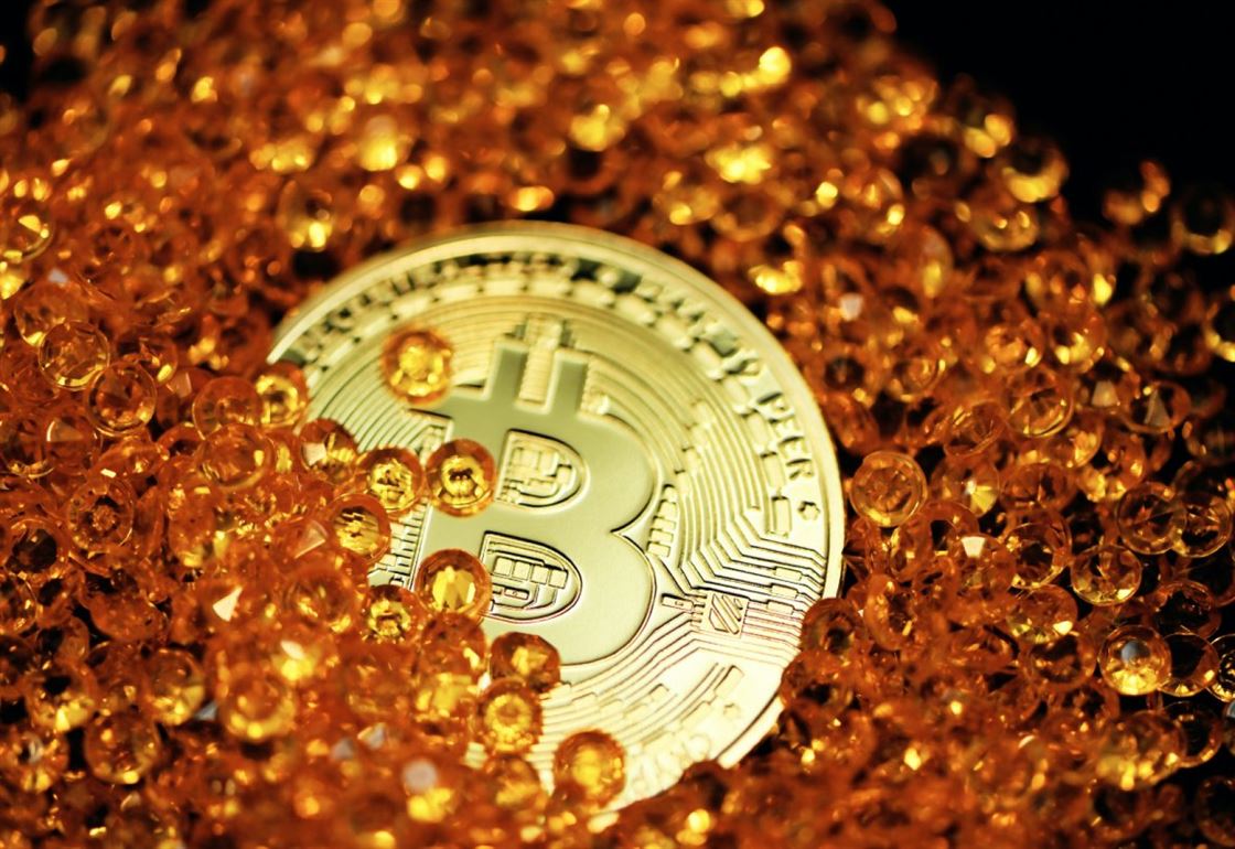 a-single-bitcoin-lays-half-buried-by-amber-colored-crystals-stockpack-unsplash.jpg A single Bitcoin lays half buried by amber colored crystals.