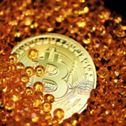 a-single-bitcoin-lays-half-buried-by-amber-colored-crystals-stockpack-unsplash.jpg A single Bitcoin lays half buried by amber colored crystals.