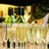 a-waiter-pouring-champagne-into-a-group-of-glasses-with-more-bottles-out-of-focus-in-the-background-stockpack-unsplash.jpg A waiter pouring champagne into a group of glasses, with more bottles out of focus in the background.