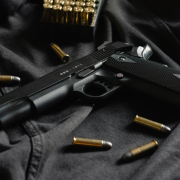 a-black-handgun-on-black-cloth-with-ammunition-stockpack-unsplash.jpg A black handgun on black cloth, with ammunition