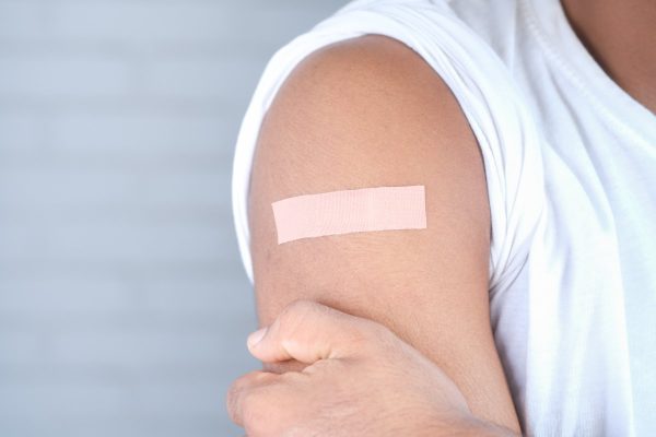 adhesive bandage on young man's arm .