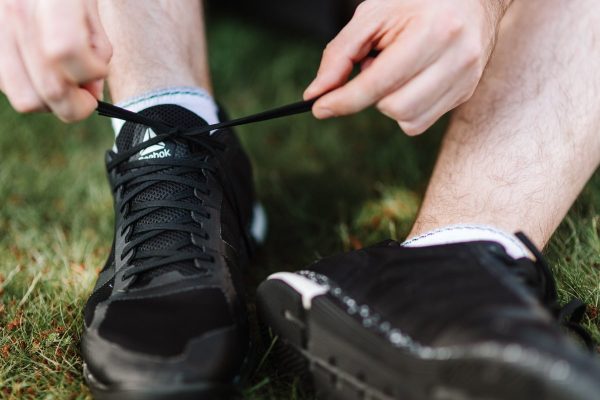 Close up view of a person tying shoelace