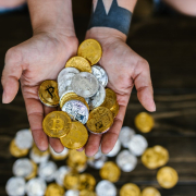 person-holding-gold-round-coins-stockpack-pexels.jpg Person holding gold round coins