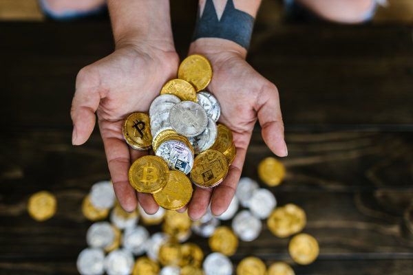 Person holding gold round coins