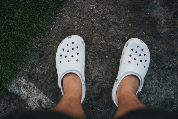 person wearing white rubber clog