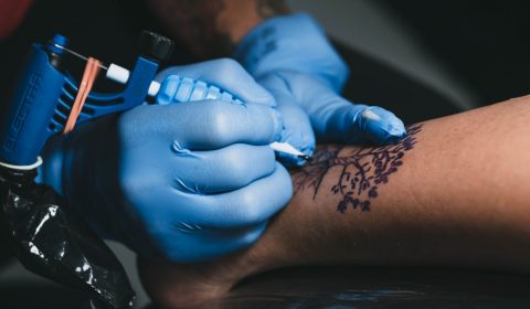 Crop master making tattoo on leg