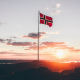 norway-flag-standing-on-cliff-stockpack-unsplash.jpg Norway flag standing on cliff