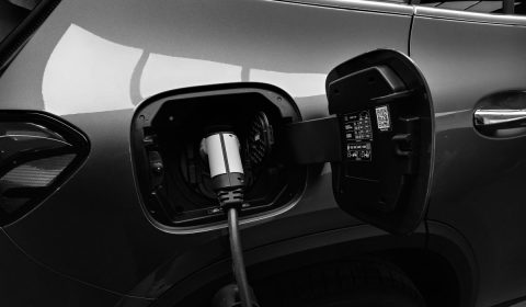 Monochrome photo of hybrid car charging