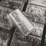 a-scottsdale-mint-stacker-bar-sits-on-top-of-a-pallet-of-raw-silver-stockpack-unsplash.jpg A Scottsdale Mint stacker bar sits on top of a pallet of raw silver.