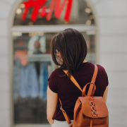 woman facing H&M store during daytime