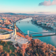 aerial photography of buildings viewing bridge and sea during daytime