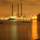 image-of-oil-refinery-at-night-across-the-sea-stockpack-unsplash.jpg Image of oil refinery at night across the sea.