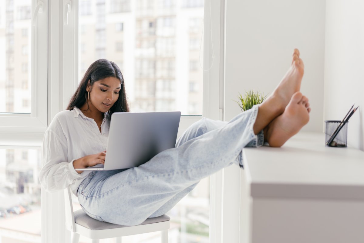a-woman-using-a-laptop-while-sitting-on-the-chair-with-her-feet-up-on-the-counter-top-stockpack-pexels.jpg A woman using a laptop while sitting on the chair with her feet up on the counter top