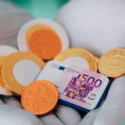 anonymous-doctor-showing-money-wearing-gloves-stockpack-pexels.jpg Anonymous doctor showing money wearing gloves