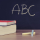 Two books beside two chalks