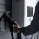 a-home-ev-charging-connector-hooked-to-the-wall-of-a-garage-stockpack-unsplash.jpg A home EV charging connector hooked to the wall of a garage.