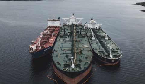 black and brown ships under cloudy sky