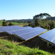 solar panels on green grass field under blue sky during daytime