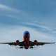 blue and red airplane on sky