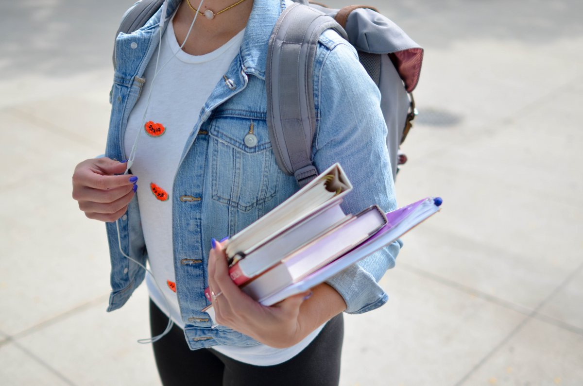 woman-wearing-blue-denim-jacket-holding-book-stockpack-unsplash.jpg woman wearing blue denim jacket holding book