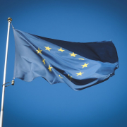 European Union flag flying in front of bright blue sky