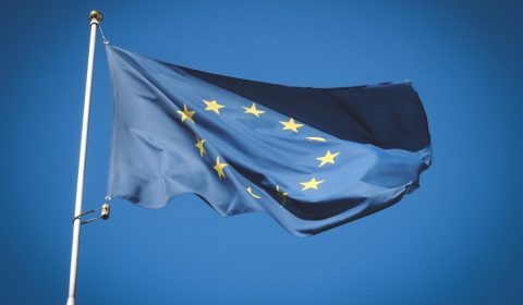European Union flag flying in front of bright blue sky