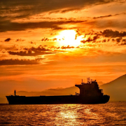 silhouette of ship on sea during sunset