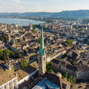 aerial view of Zurich skyline showing church tower, old town and lake.