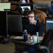 man-wearing-glasses-and-headphone-working-from-office-desk-stockpack-unsplash.jpg Man wearing glasses and headphone working from office desk.