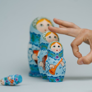 Person holding blue and white ceramic owl figurine