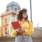 woman-in-yellow-jacket-holding-books-stockpack-pexels.jpg Woman in yellow jacket holding books
