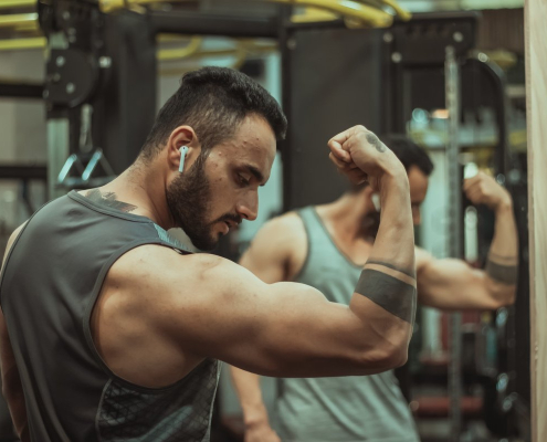 man in gray tank top doing push up