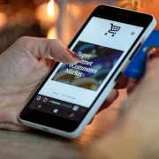 person-using-black-and-white-smartphone-and-holding-blue-card-stockpack-pexels.jpg Person using black and white smartphone and holding blue card