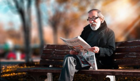 Photo of man reading newspaper