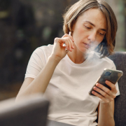 woman-smoking-while-holding-her-phone-stockpack-pexels.jpg Woman smoking while holding her phone